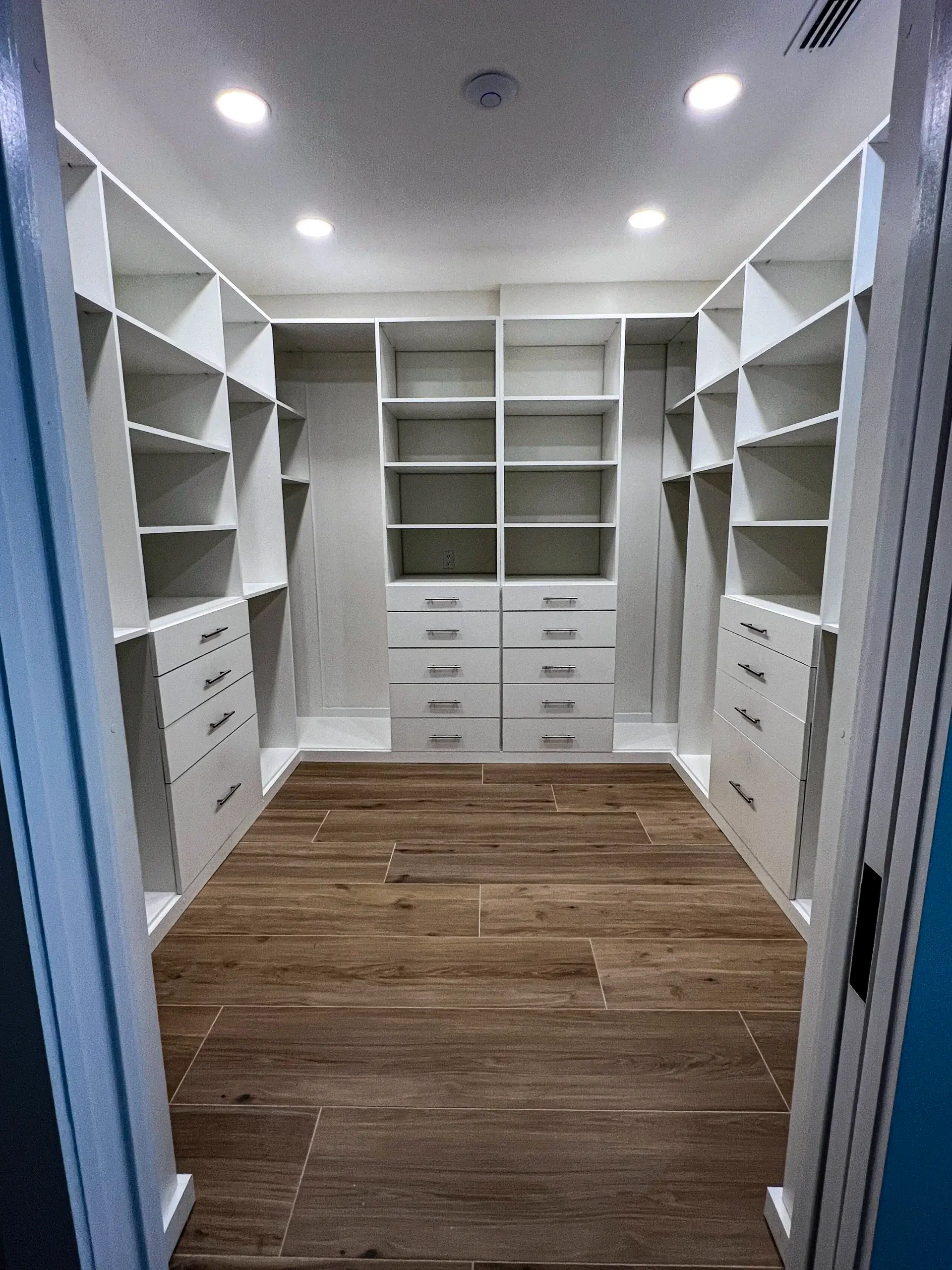 White Walk-In Closet - Custom white cabinetry, drawers and shelving in South Florida
