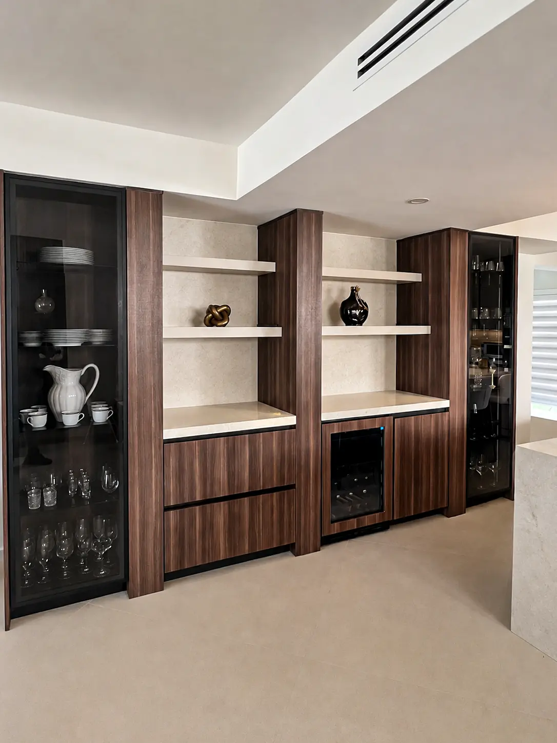 Custom walnut wet bar with glass display and wine cooler cabinets in Fort Lauderdale, FL