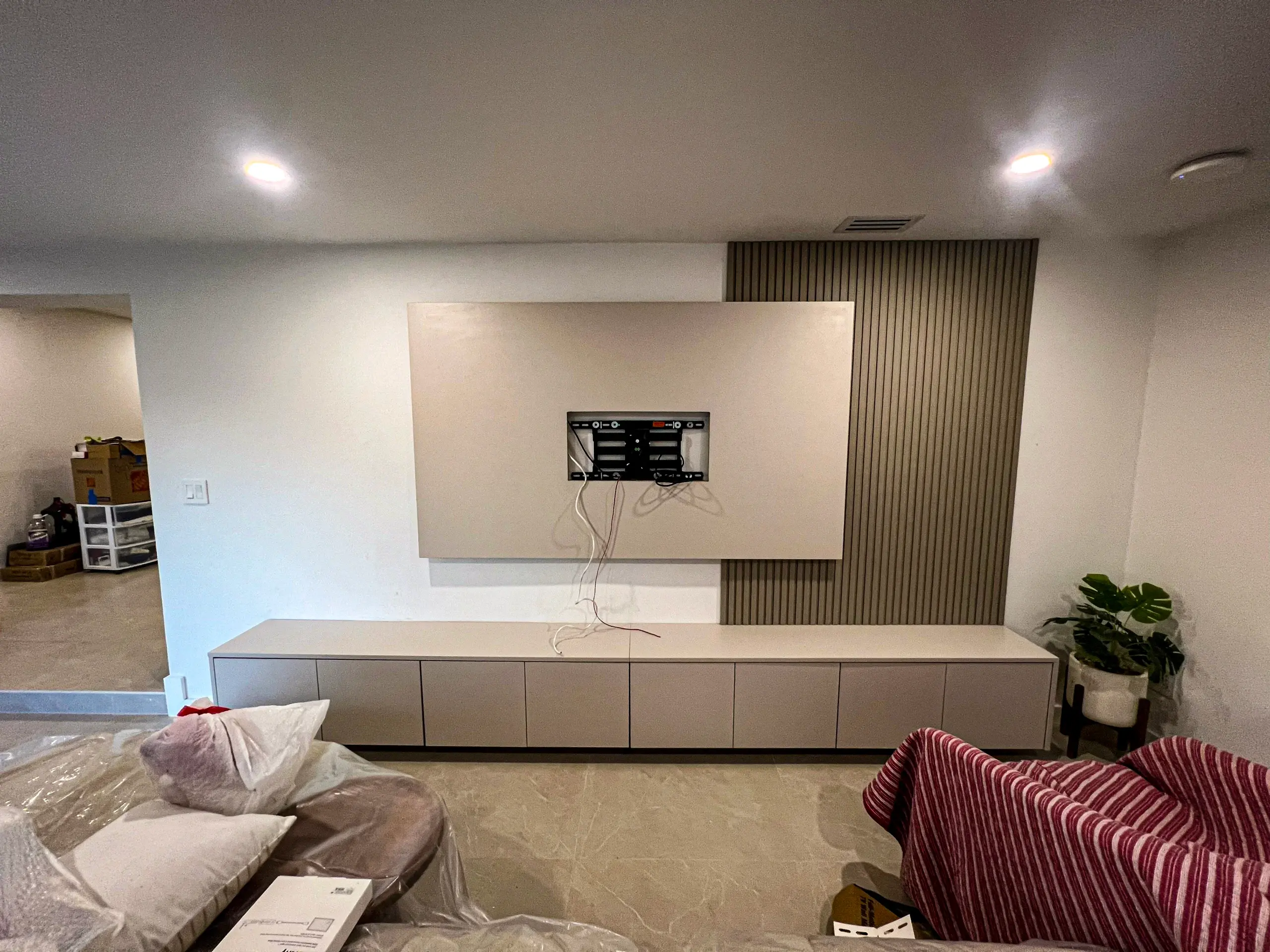 Custom modern entertainment center with glass display shelving in Weston, FL