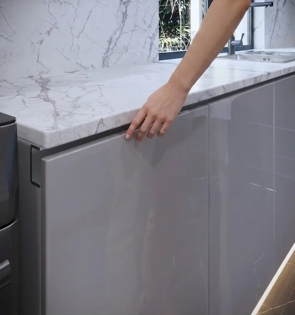 Hand reaching into the gola channel to open a handleless base cabinet door, Custom Closet Florida
